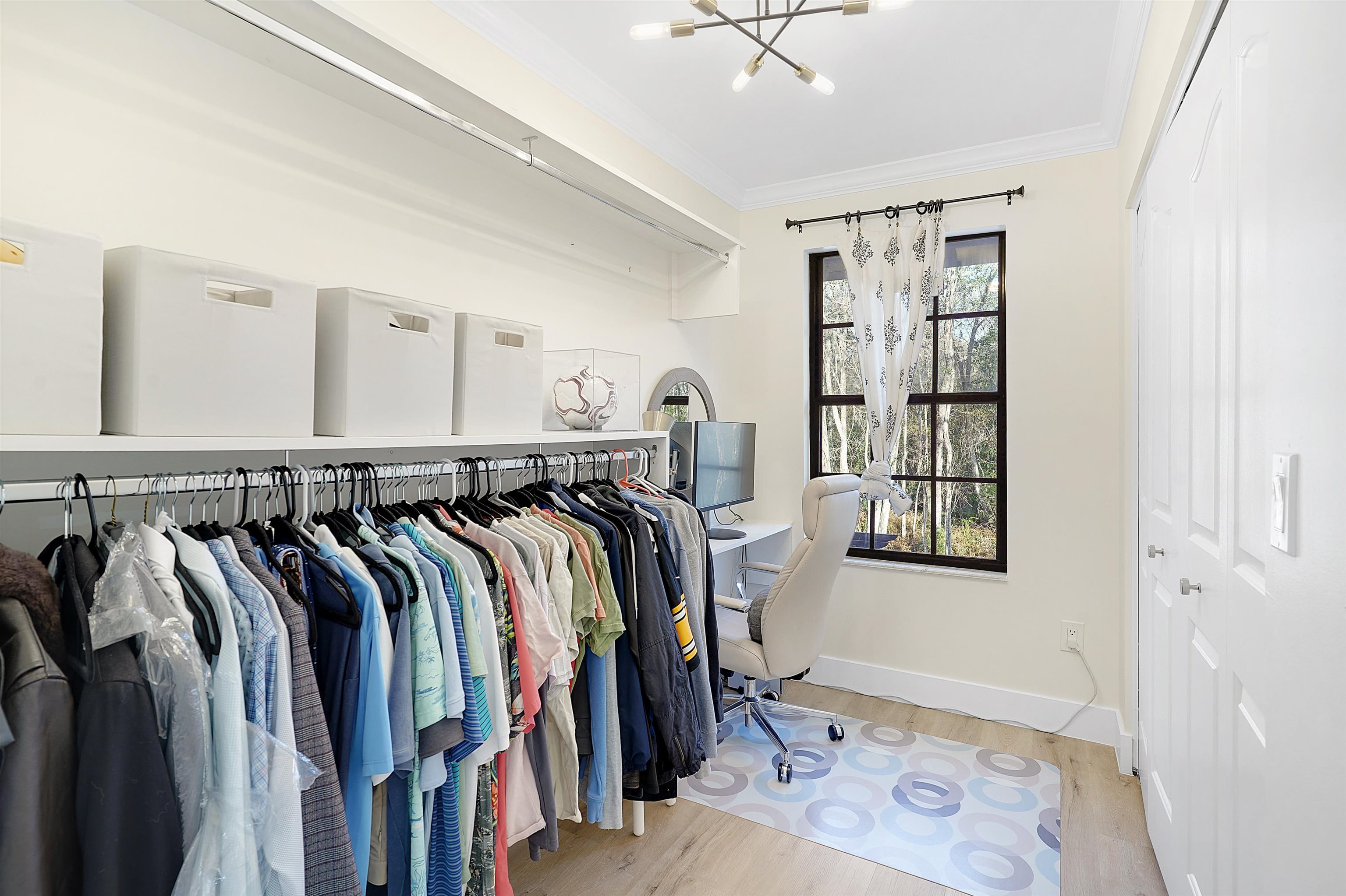 3020 Mac Road St. Augustine, FL 32086 - Photo 23 of 49 Walk in closet with light wood-style flooring and suspended lighting