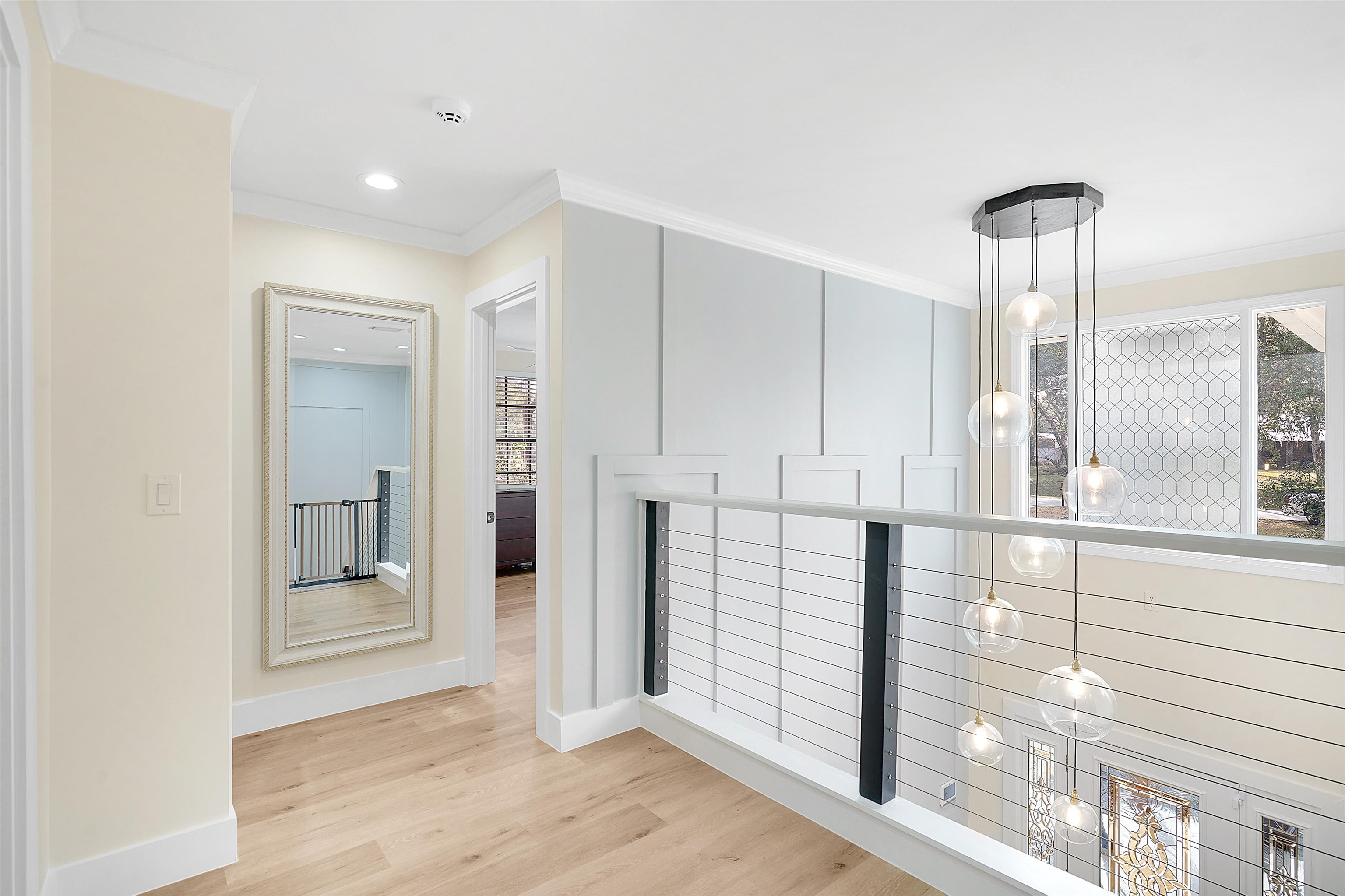 3020 Mac Road St. Augustine, FL 32086 - Photo 25 of 49 Hallway with light wood finished floors, crown molding, recessed lighting, and an upstairs landing