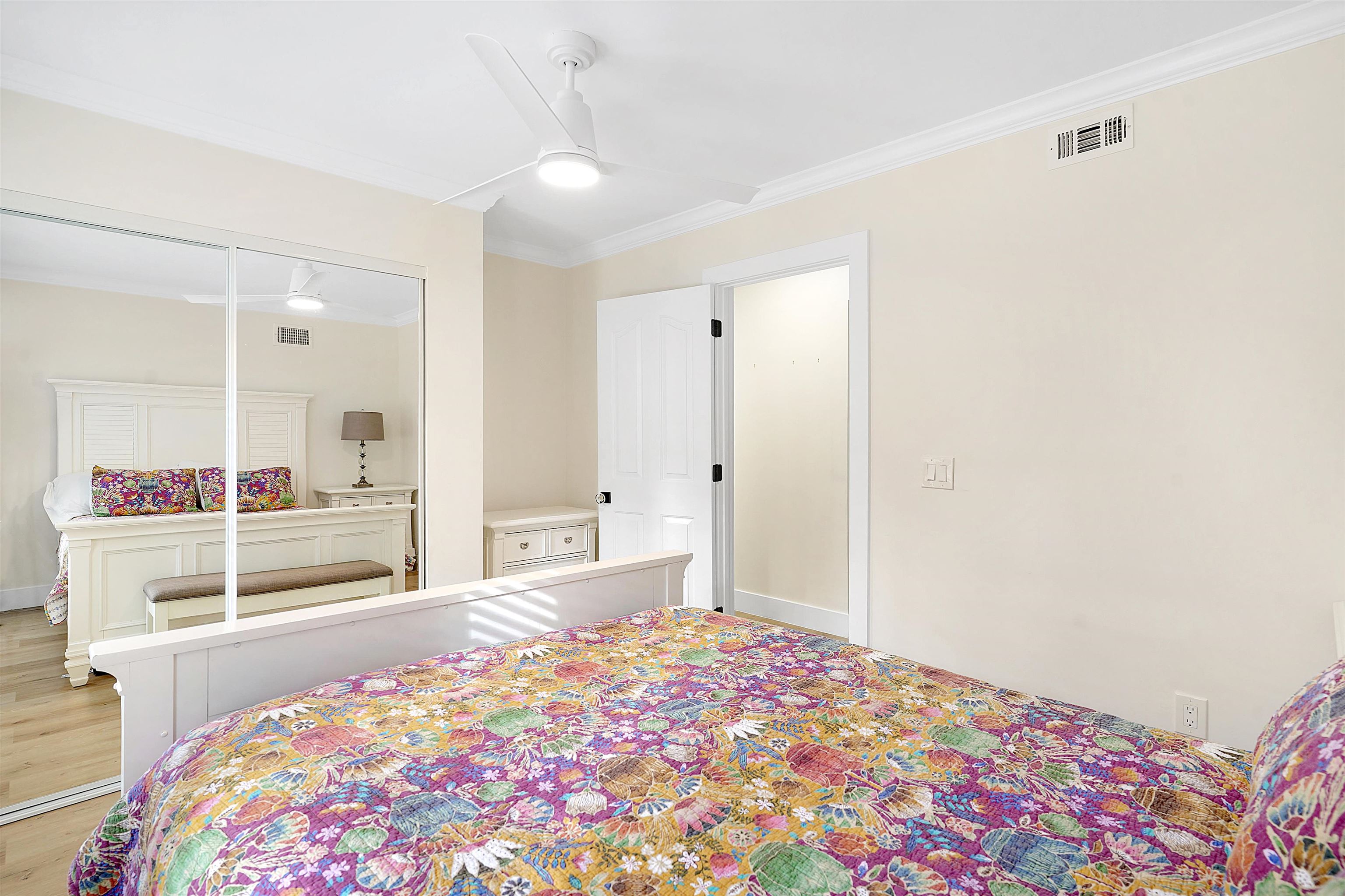 3020 Mac Road St. Augustine, FL 32086 - Photo 27 of 49 Bedroom with ornamental molding, a closet, light wood-type flooring, and a ceiling fan