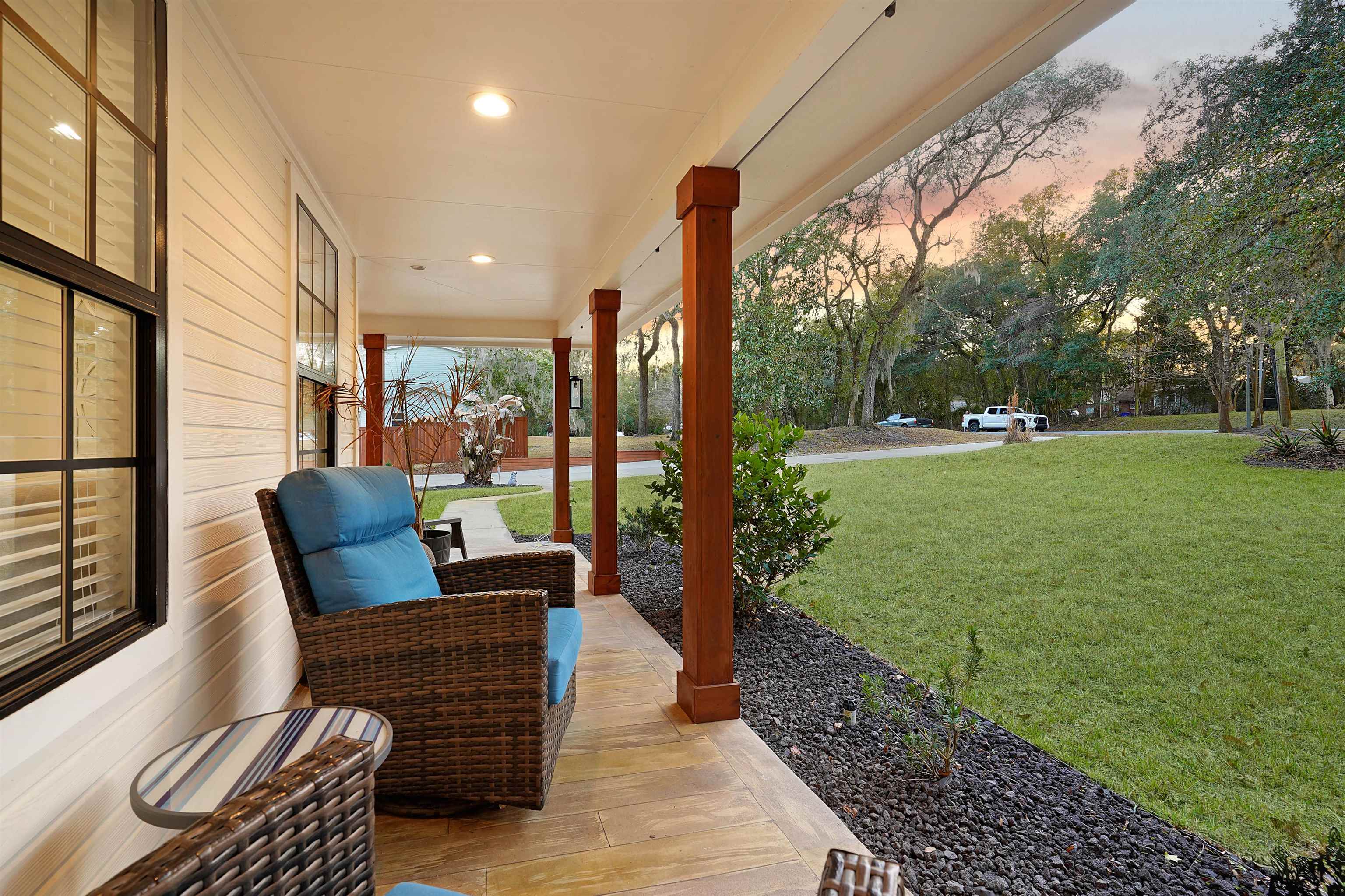3020 Mac Road St. Augustine, FL 32086 - Photo 42 of 49 Patio terrace at dusk featuring a porch and a lawn
