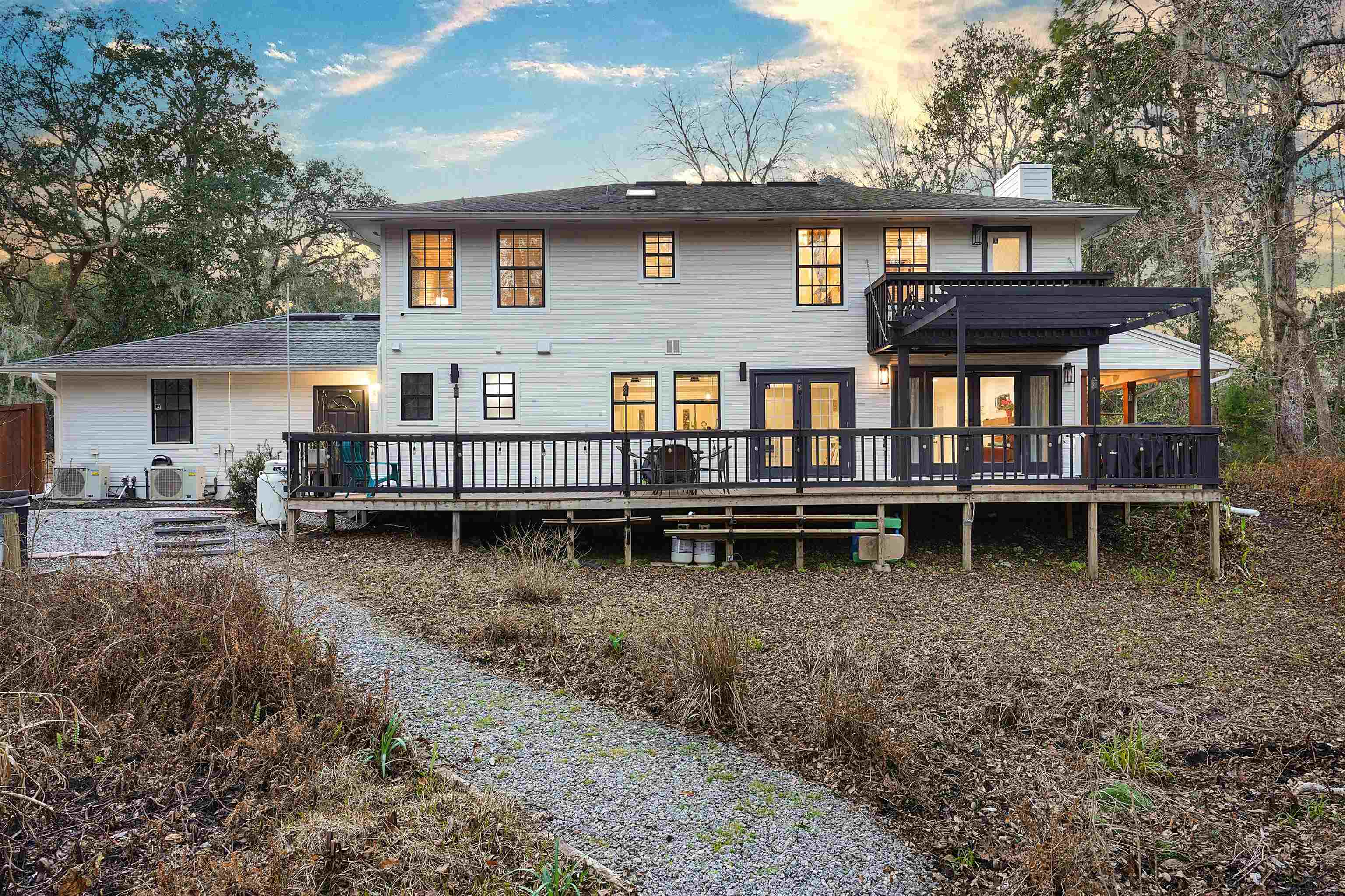 3020 Mac Road St. Augustine, FL 32086 - Photo 45 of 49 Back of property at dusk featuring a wooden deck and a chimney