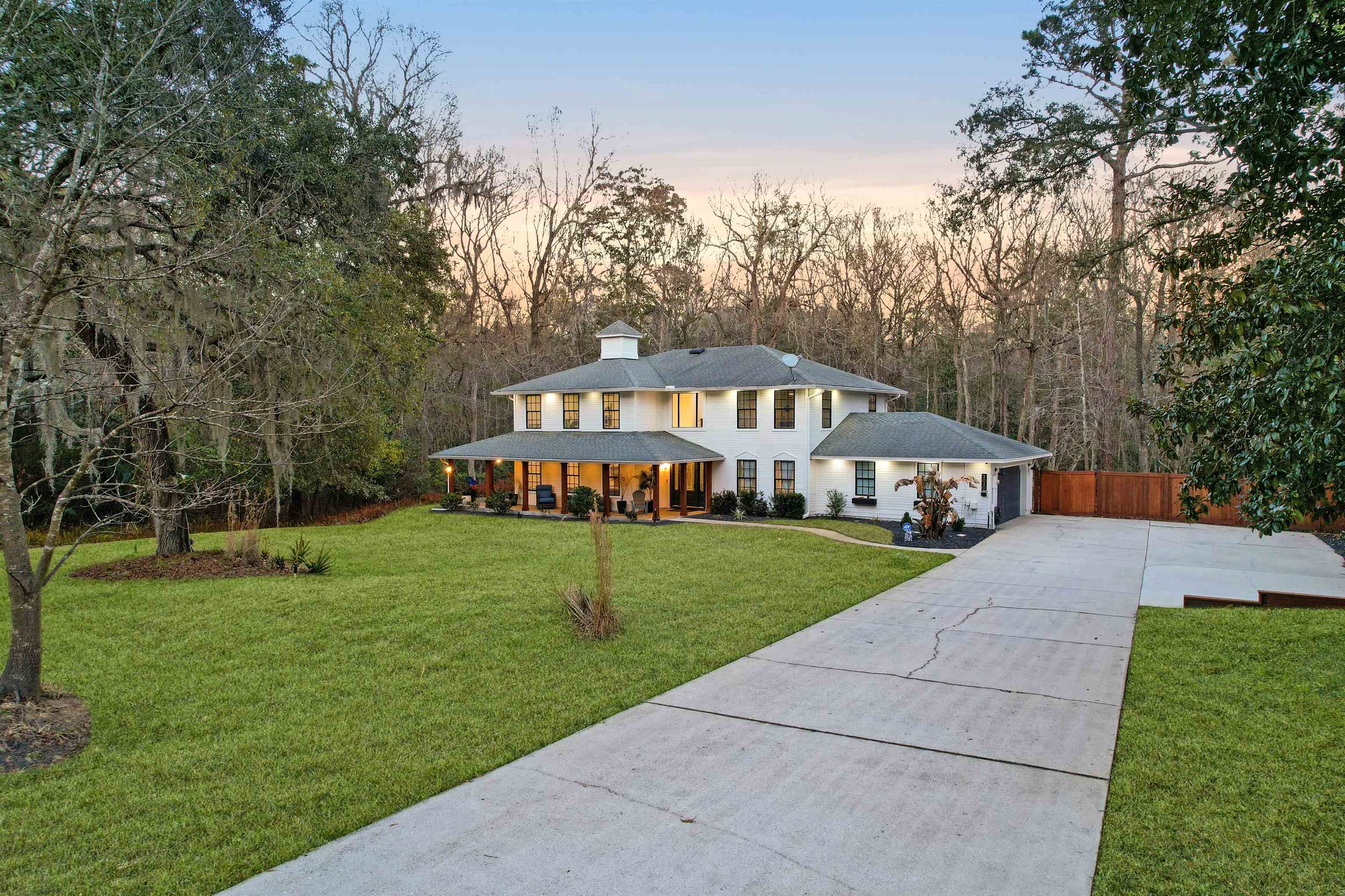 3020 Mac Road St. Augustine, FL 32086 - Photo 6 of 49 View of front of property featuring driveway, covered porch, a chimney, and view of wooded area