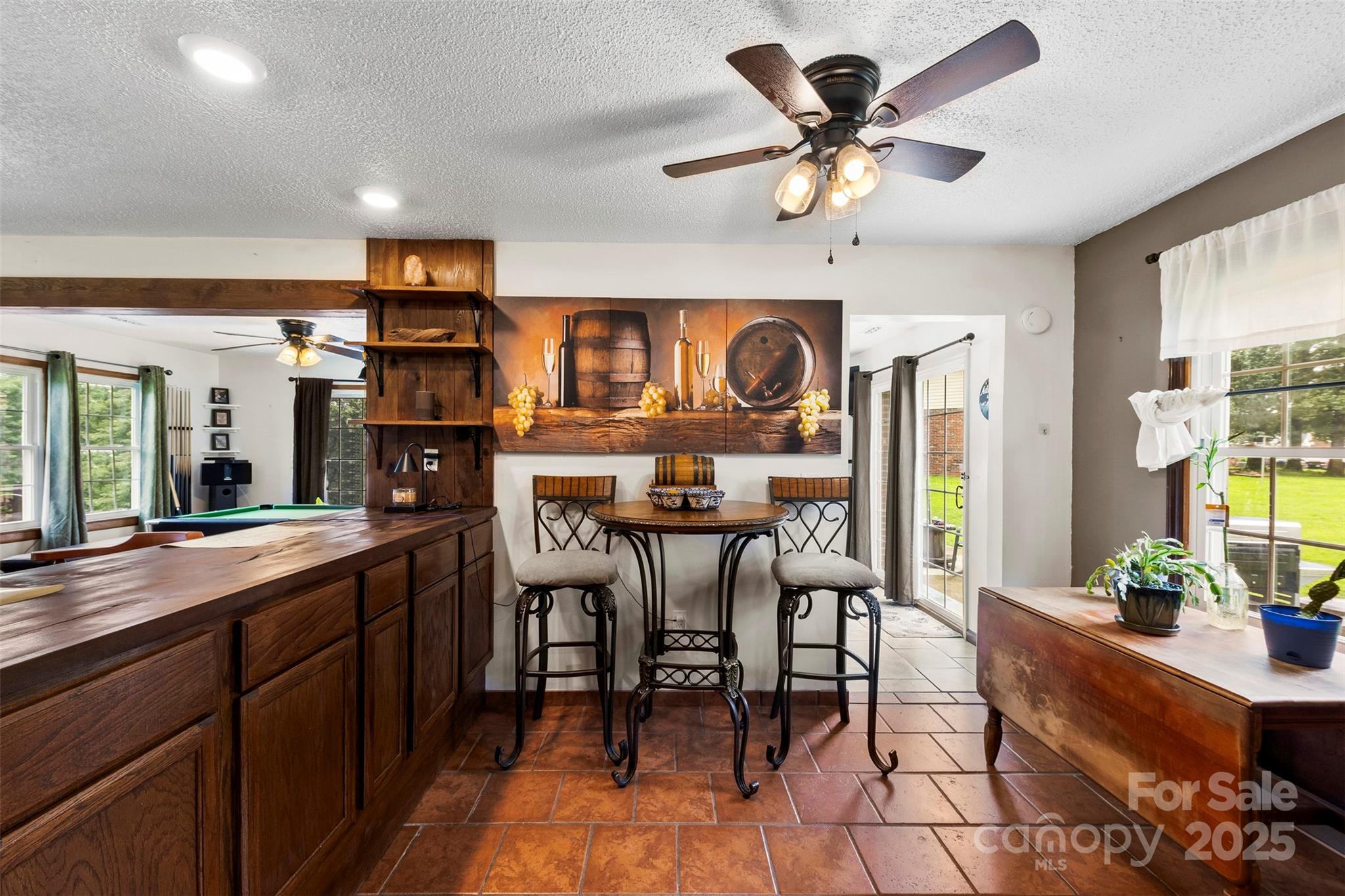 111 Hicks Road, Unit 9 Grover, NC 28073 - Photo 13 of 29 a kitchen with stainless steel appliances kitchen island granite countertop a dining table chairs and a refrigerator