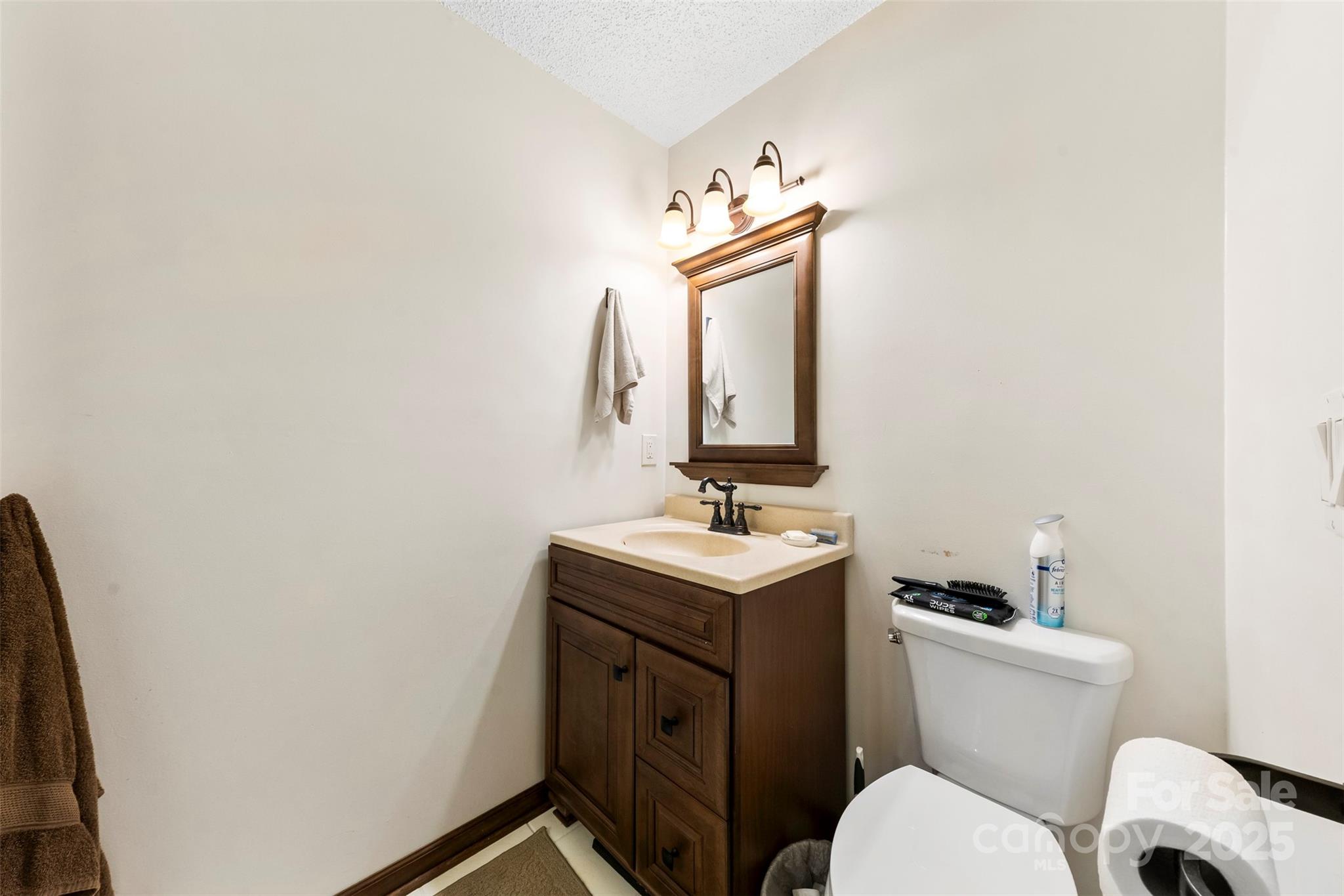 111 Hicks Road, Unit 9 Grover, NC 28073 - Photo 21 of 29 a bathroom with a toilet a sink and mirror
