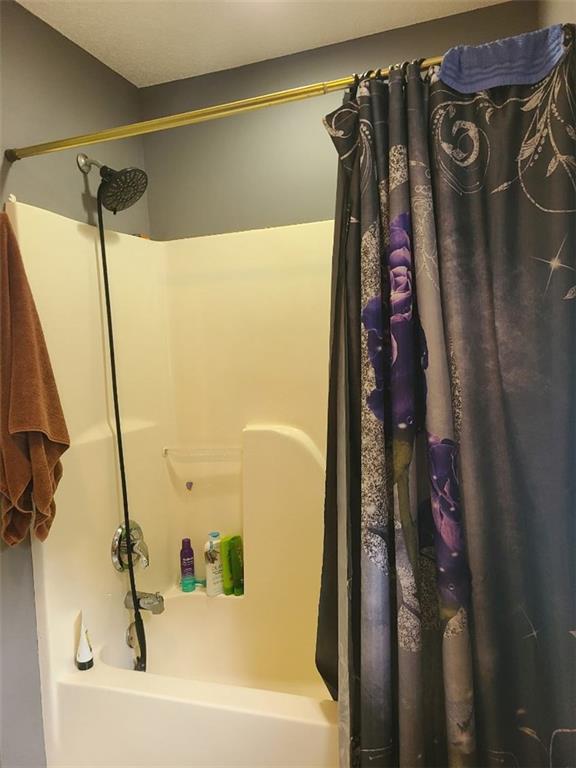 805 Gose Road Forsyth, GA 31029 - Photo 22 of 29 a bathroom with a shower and a tub