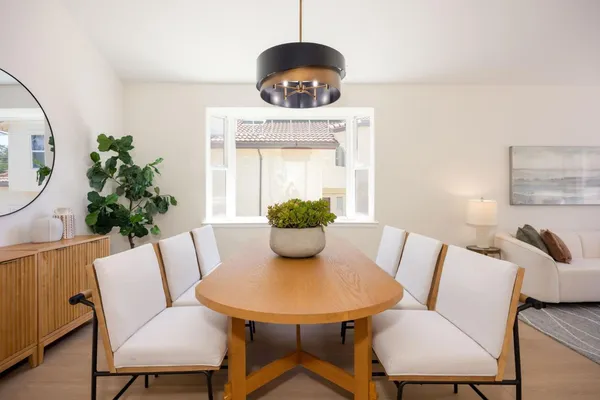 a view of a dining room with furniture window and wooden floor