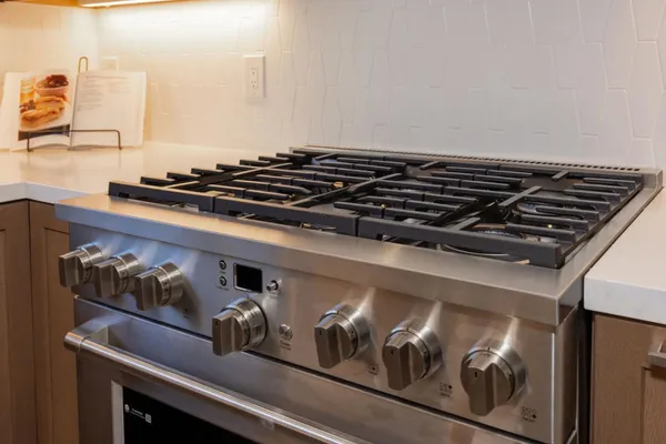 a kitchen with stainless steel appliances granite countertop a sink and a refrigerator