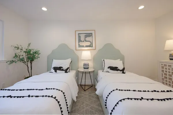 a bedroom with a bed and a large window