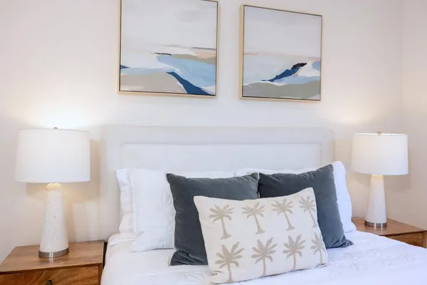 a bedroom with a bed and a large window