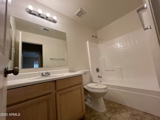 a bathroom with a double vanity sink toilet mirror and bathtub