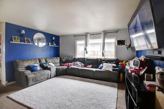 a living room with furniture a fireplace and a window