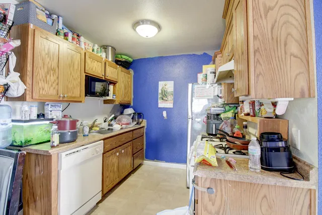 a kitchen with a sink stove and wooden cabinets