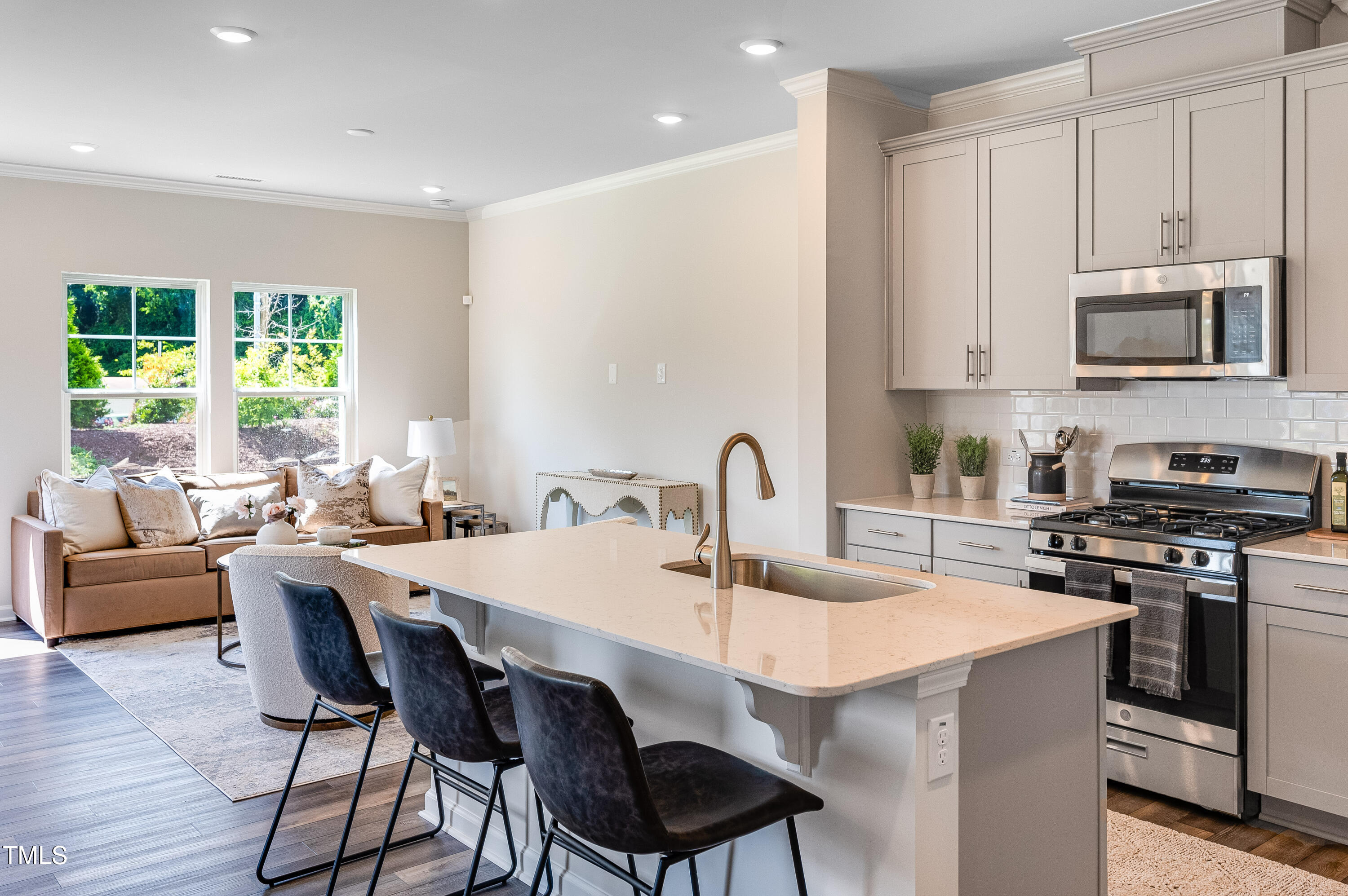 2217 Titanium Rock Road Durham, NC 27704 - Photo 2 of 27 a kitchen with stainless steel appliances granite countertop a stove a sink a microwave a dining table and chairs