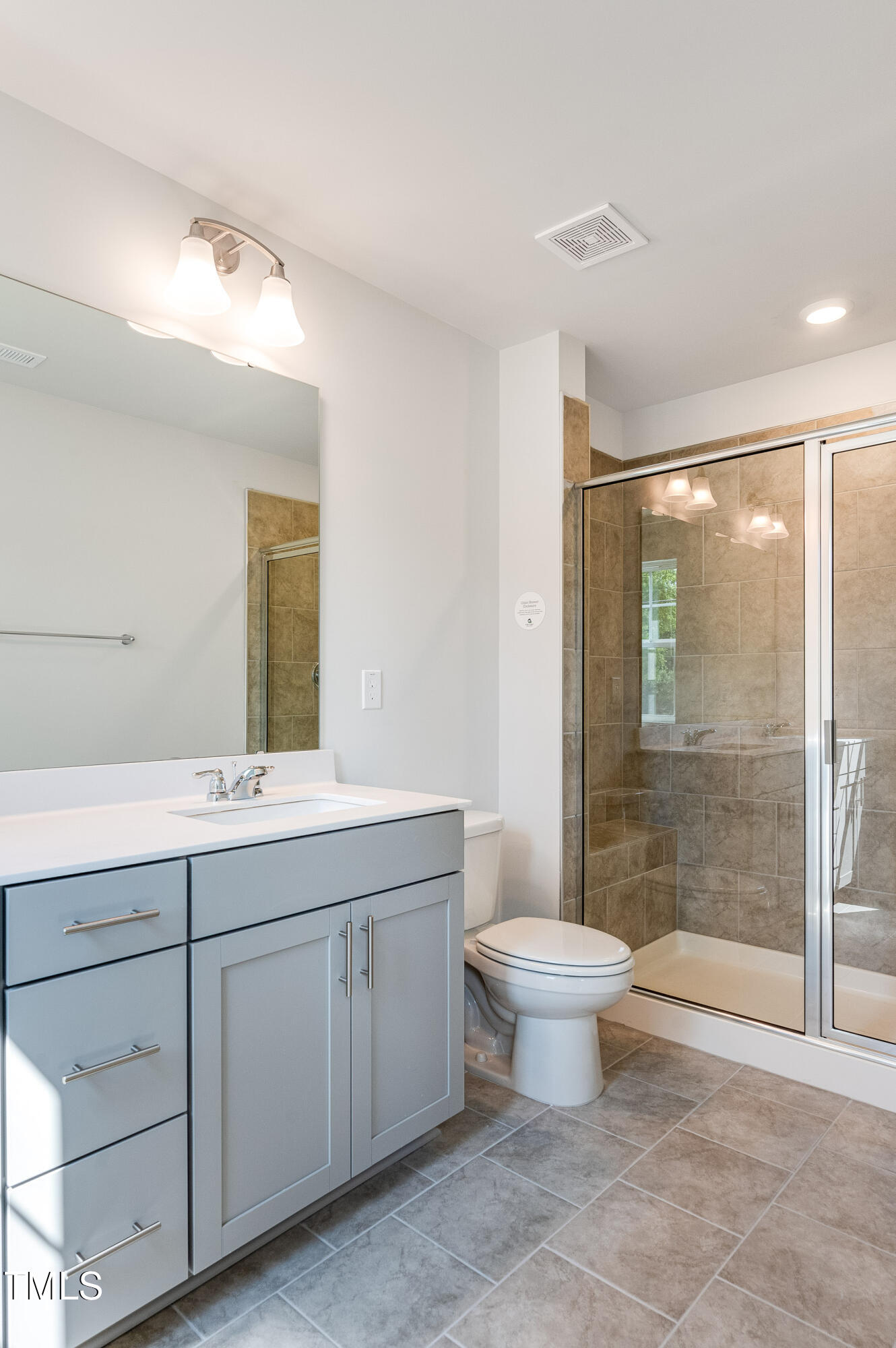 2217 Titanium Rock Road Durham, NC 27704 - Photo 21 of 27 a bathroom with a double vanity sink mirror and toilet