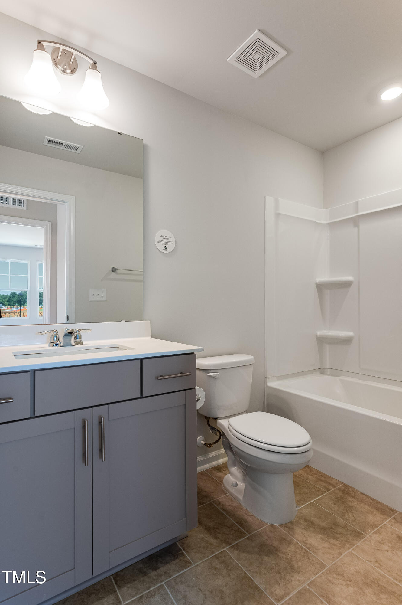 2217 Titanium Rock Road Durham, NC 27704 - Photo 26 of 27 a bathroom with a sink toilet and shower
