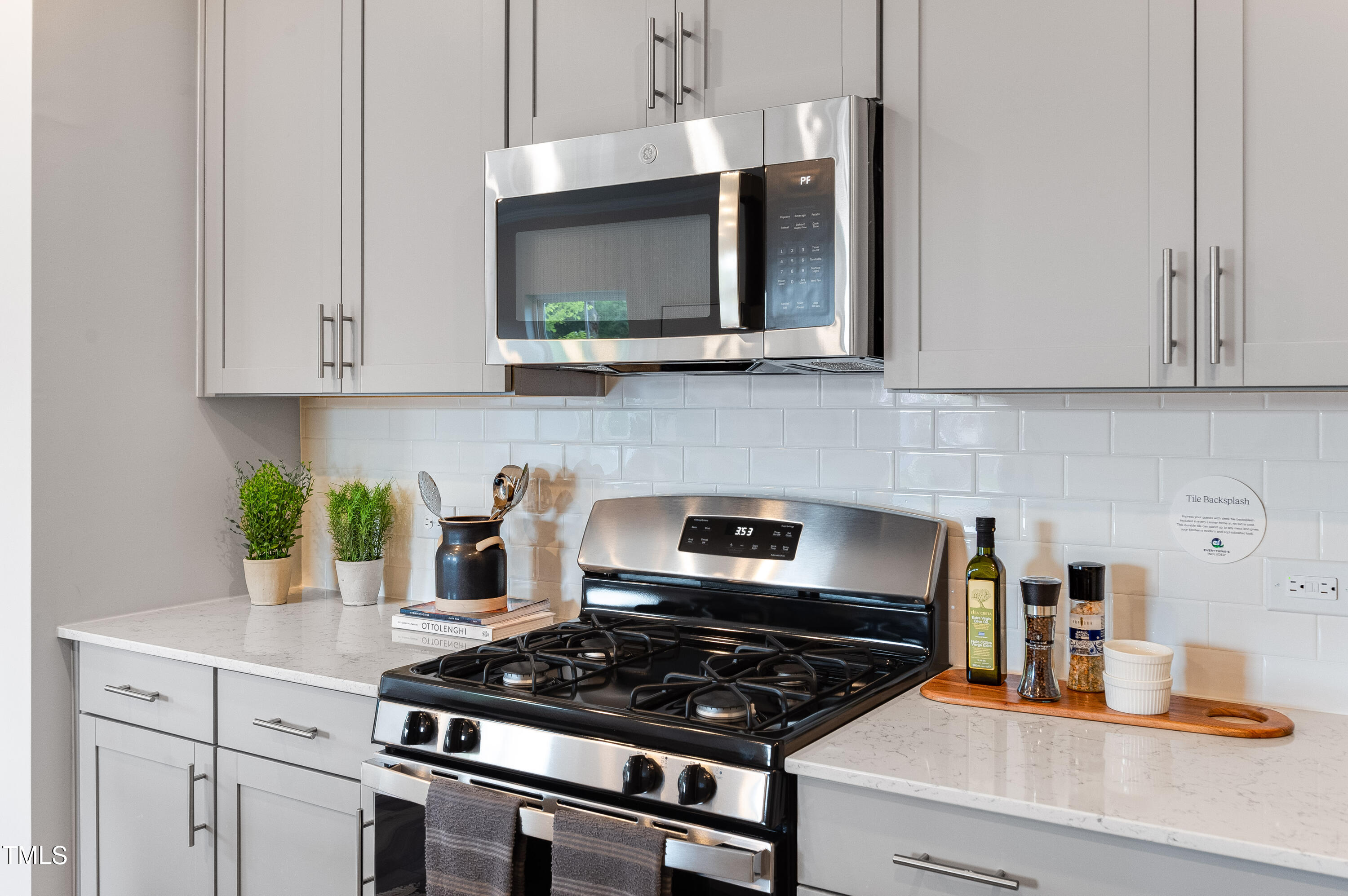 2217 Titanium Rock Road Durham, NC 27704 - Photo 6 of 27 a kitchen with stainless steel appliances granite countertop a stove a microwave and cabinets