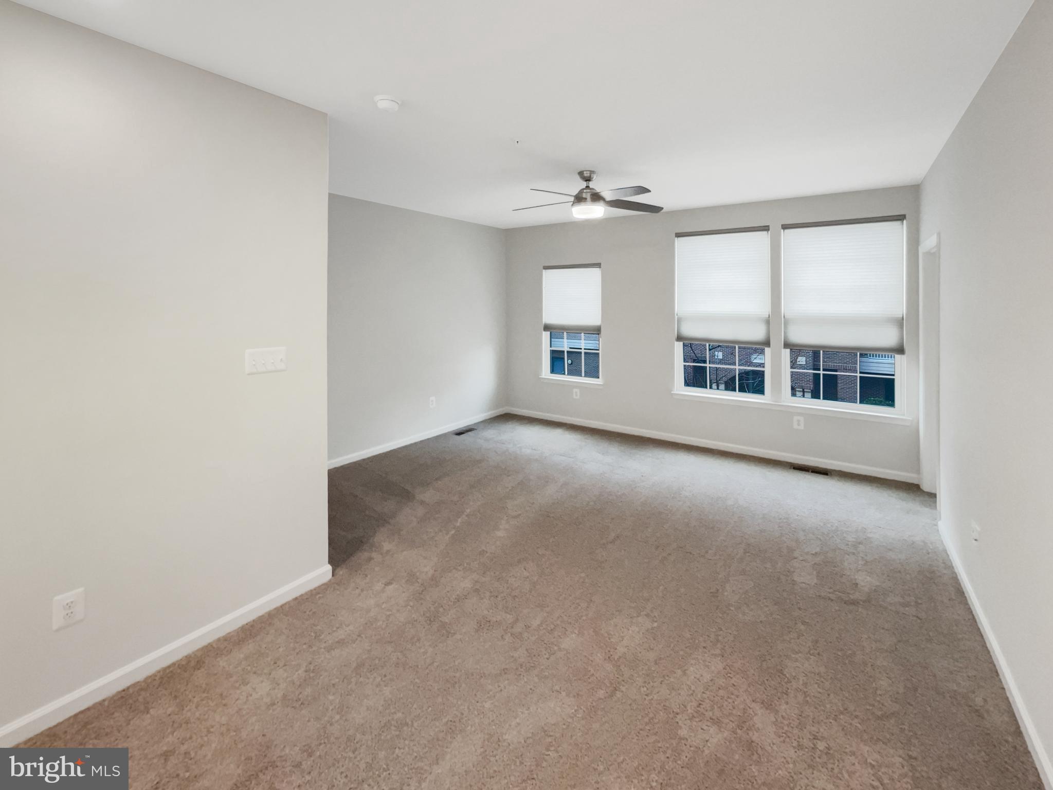 13731 Endeavour Drive Herndon, VA 20171 - Photo 21 of 37 an empty room with windows and chandelier