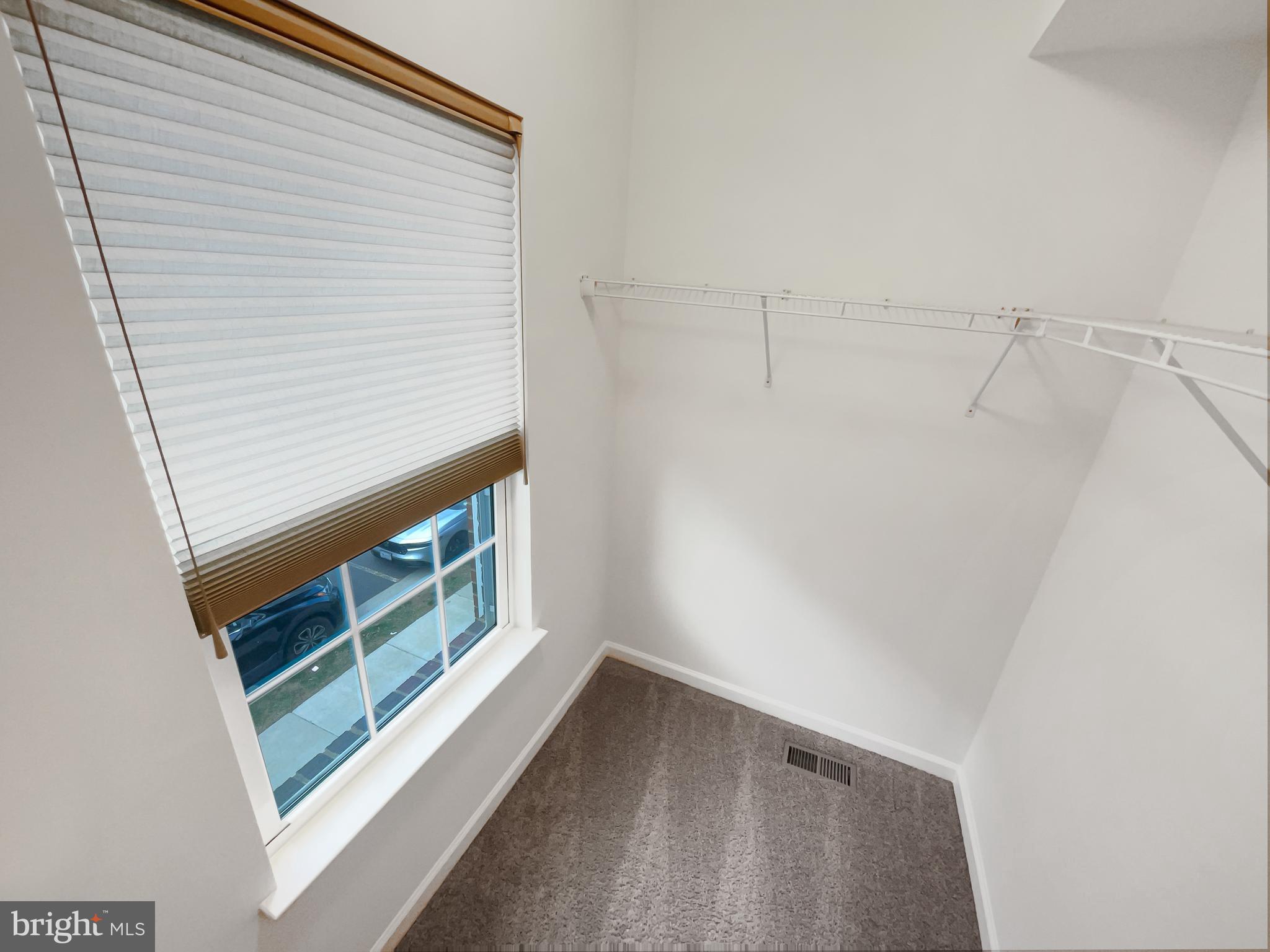 13731 Endeavour Drive Herndon, VA 20171 - Photo 23 of 37 a view of an empty room with wooden floor and a window