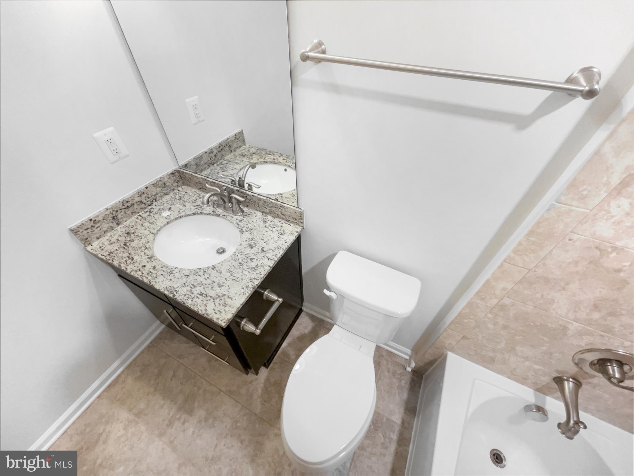 13731 Endeavour Drive Herndon, VA 20171 - Photo 29 of 37 a bathroom with a sink toilet and mirror