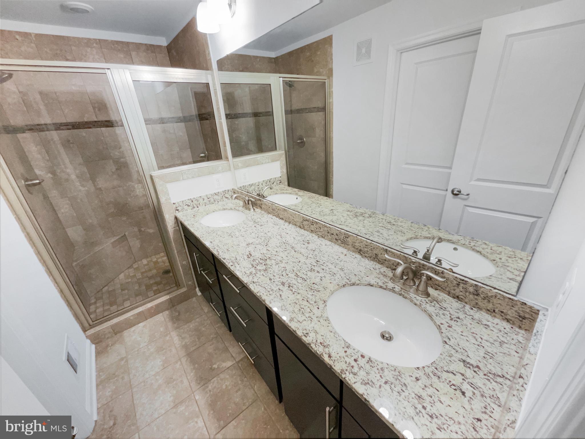 13731 Endeavour Drive Herndon, VA 20171 - Photo 7 of 37 a bathroom with a granite countertop sink and mirror