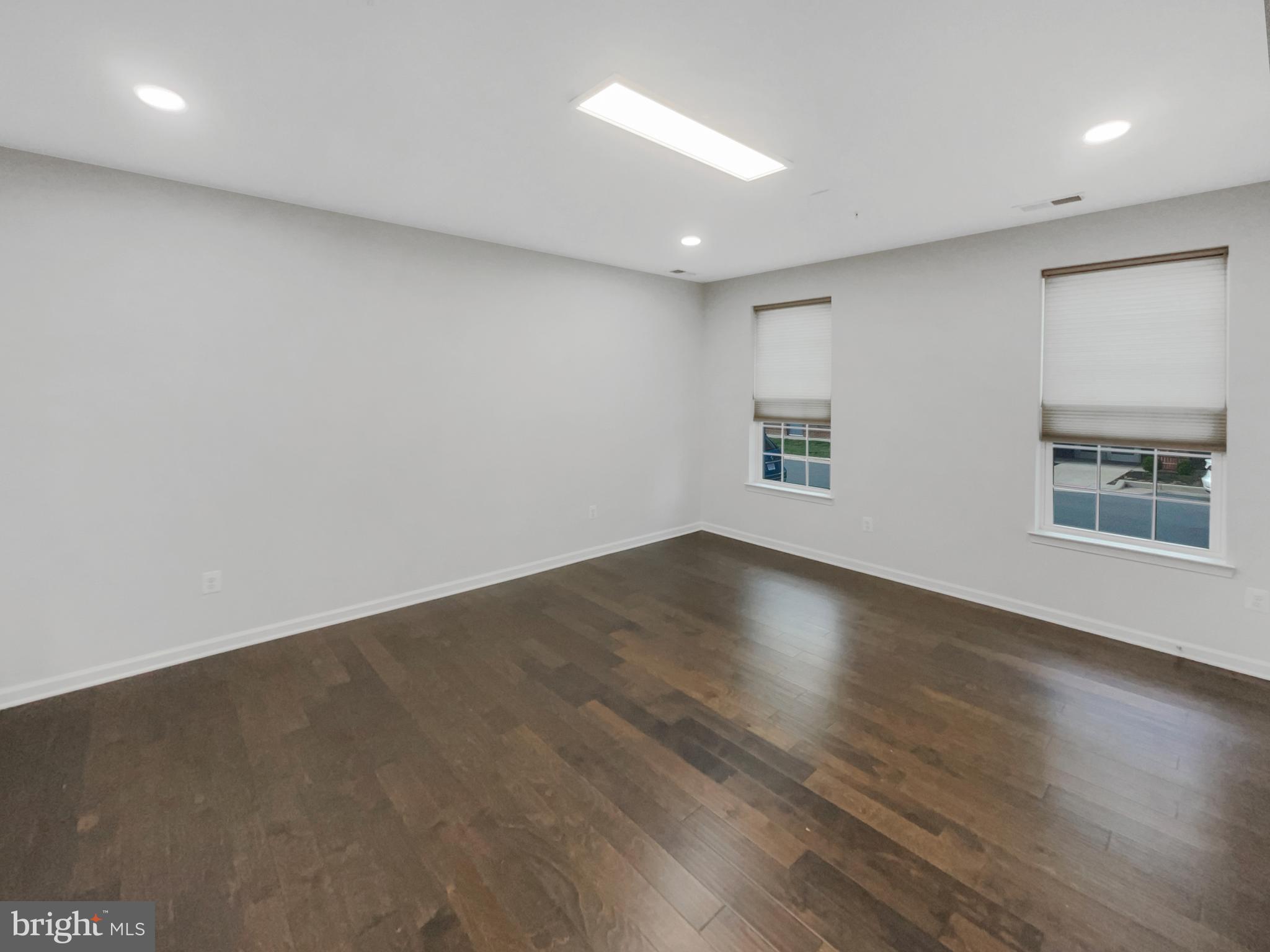 13731 Endeavour Drive Herndon, VA 20171 - Photo 9 of 37 an empty room with wooden floor and windows