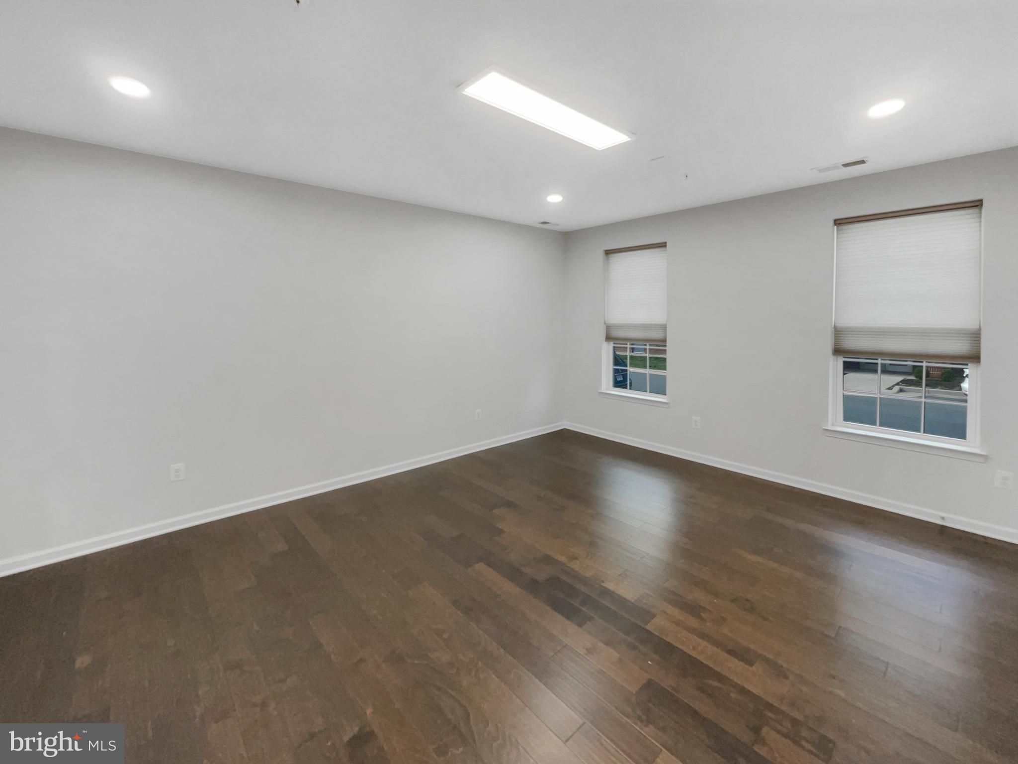13731 Endeavour Drive Herndon, VA 20171 - Photo 10 of 37 an empty room with wooden floor and windows