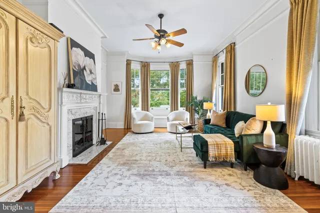 a living room with fireplace furniture and a flat screen tv