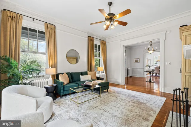 a large kitchen with kitchen island a large counter top a sink a window and stainless steel appliances