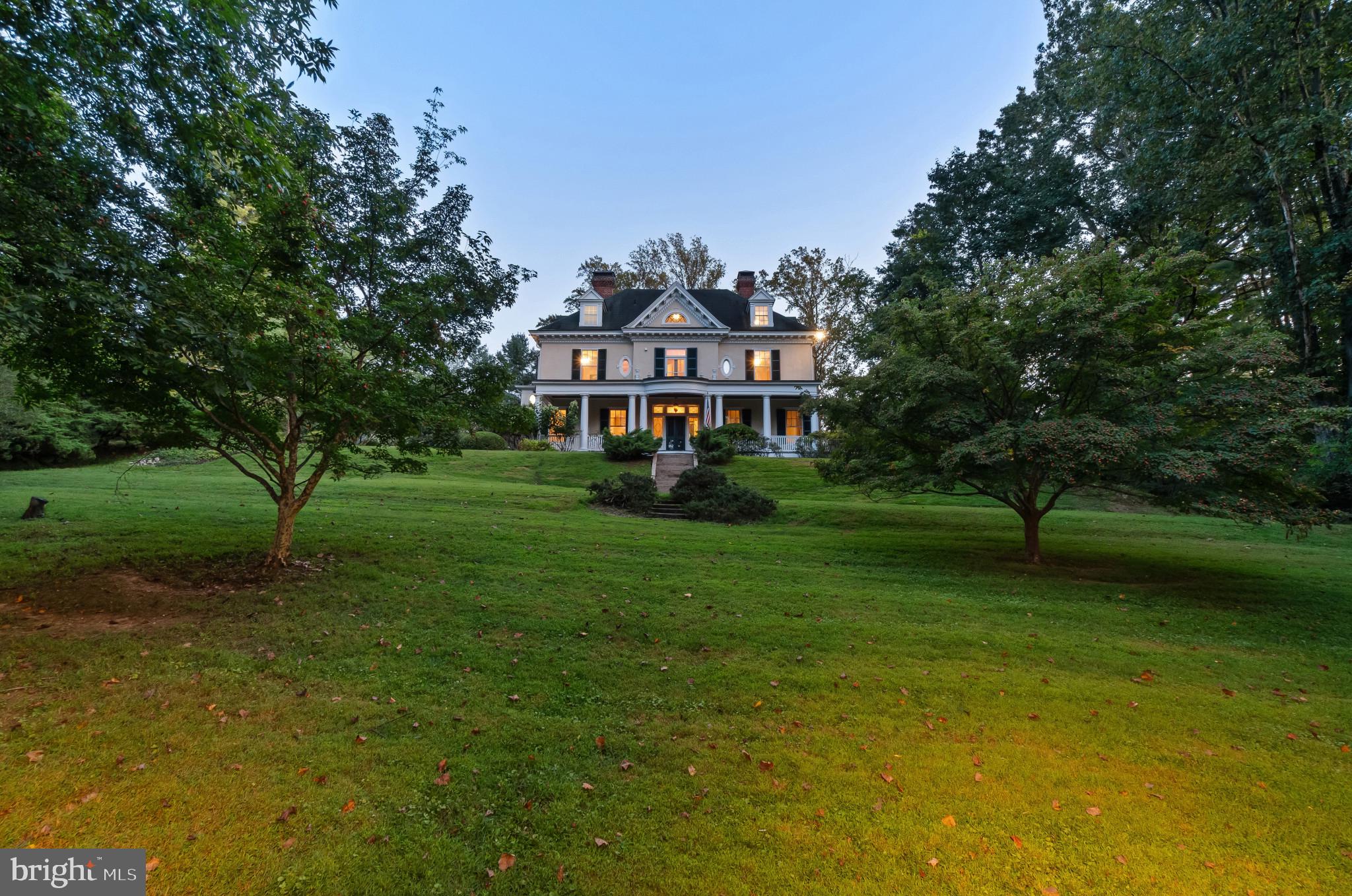 1926 Ruxton Road Ruxton, MD 21204 - Photo 2 of 108 a view of a big house with a big yard and large trees