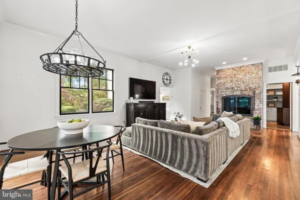 a view of a dining room with furniture wooden floor and chandelier