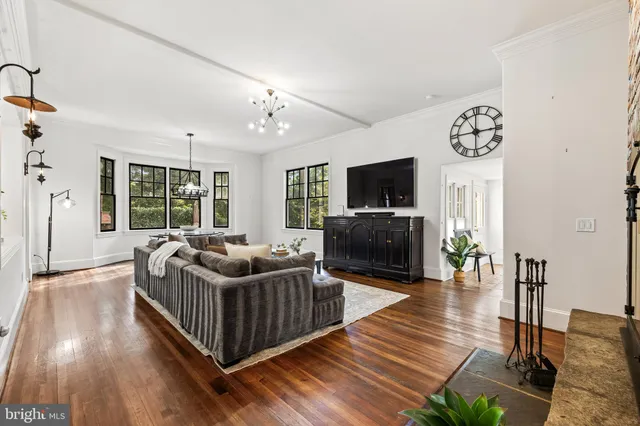 a view of a dining room with furniture wooden floor and chandelier