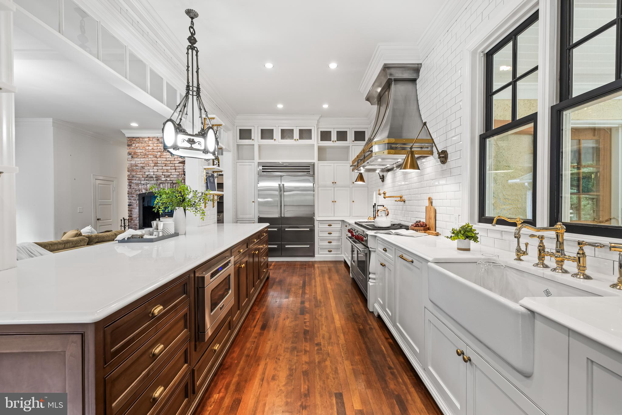 1926 Ruxton Road Ruxton, MD 21204 - Photo 26 of 106 a large kitchen with kitchen island a large counter top a sink a window and stainless steel appliances