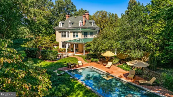 a aerial view of a house with table and chairs and a fire pit
