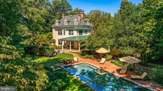 a aerial view of a house with table and chairs and a fire pit