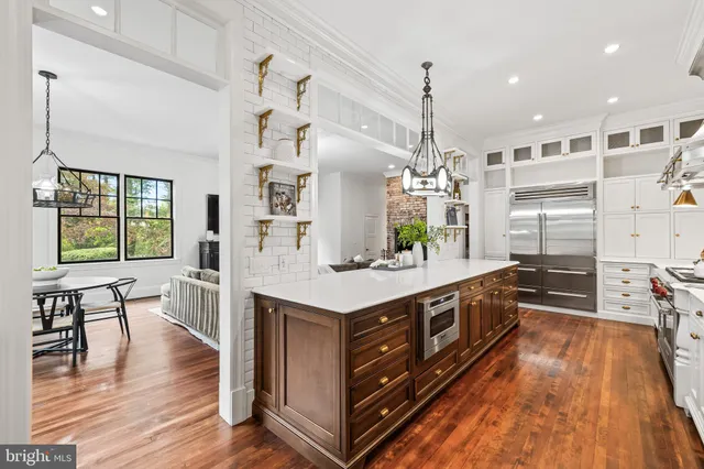 a bedroom with a bed a chandelier and a window