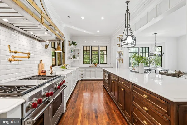 a bedroom with a bed a chandelier and a window