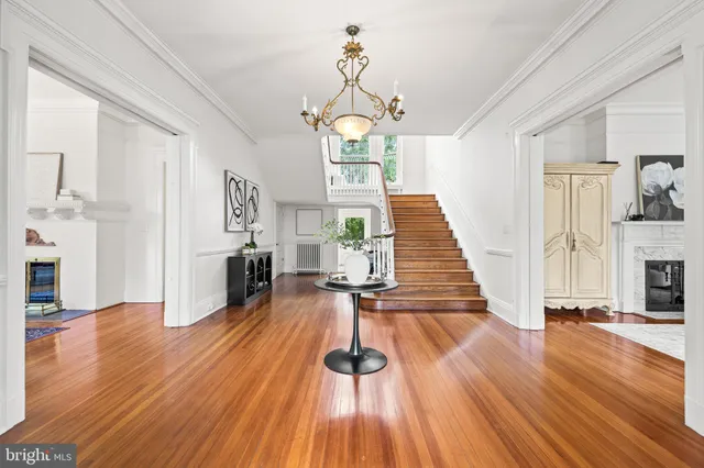 a living room with furniture a chandelier and a fireplace