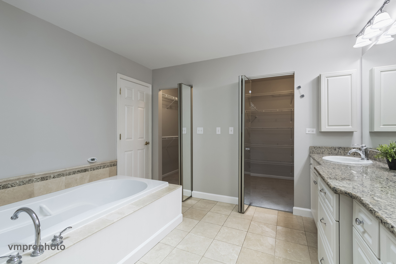 246 Montclair Road Vernon Hills, IL 60061 - Photo 22 of 42 a spacious bathroom with a granite countertop sink and a mirror