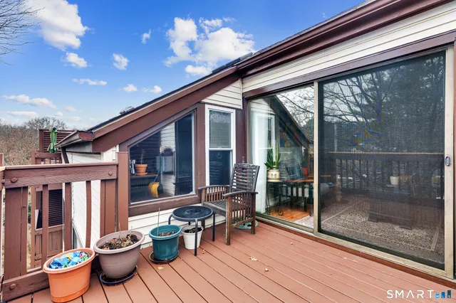 a view of a patio with a dining table and chairs