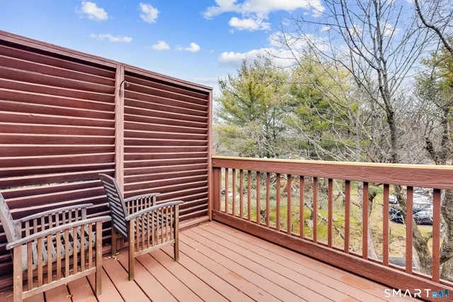 a view of balcony with wooden floor and fence