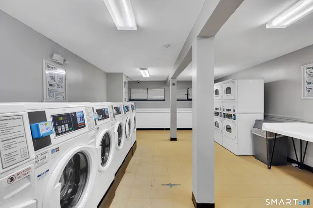 a view of a kitchen with stainless steel appliances refrigerator and cabinets