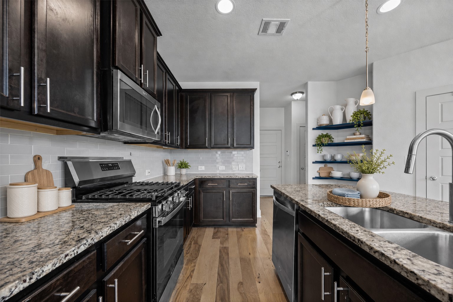 2303 Capulet Street Austin, TX 78741 - Photo 5 of 24 The kitchen features a gas range and sleek stainless steel appliances, offering both style and everyday functionality. This picture is virtually staged.