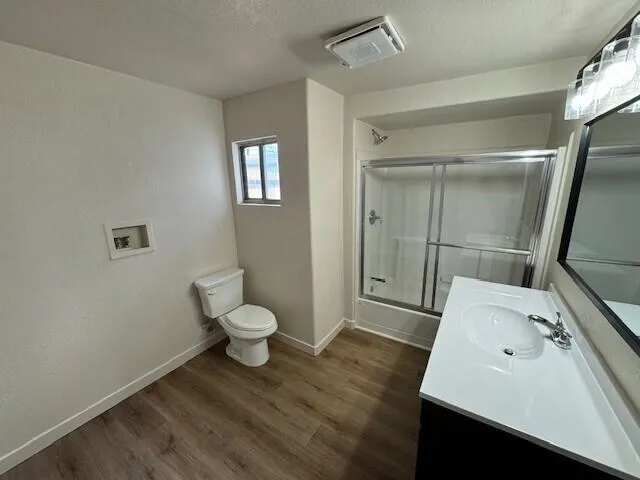 a bathroom with a sink toilet and shower