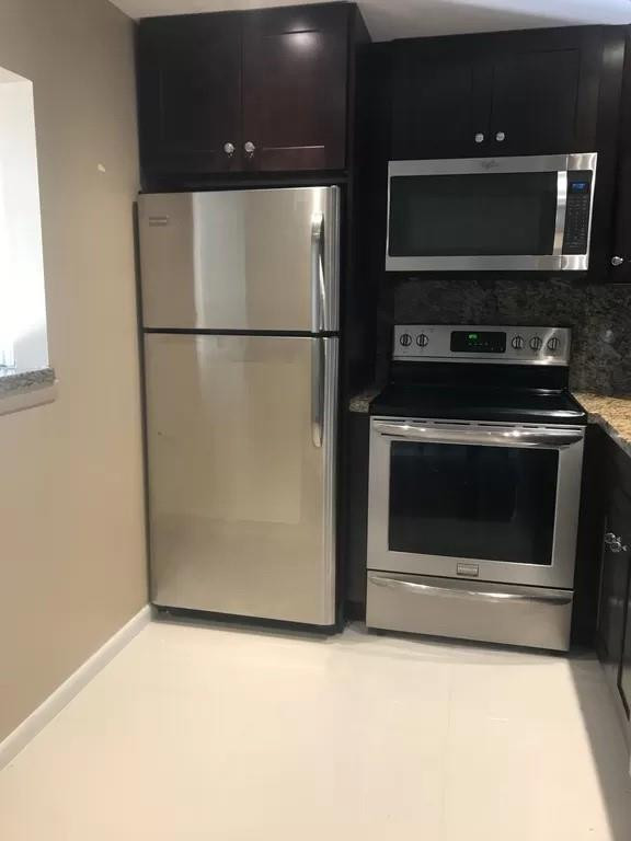 21 Dorset A Boca Raton, FL 33434 - Photo 2 of 7 a kitchen with a stove and a microwave