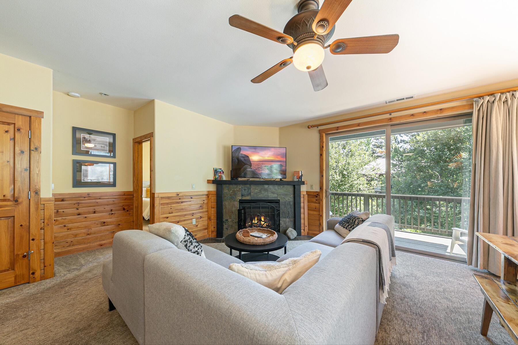 10903 Cinnabar Way, Unit 4 Truckee, CA 96161 - Photo 11 of 28 a living room with furniture a fireplace and a floor to ceiling window
