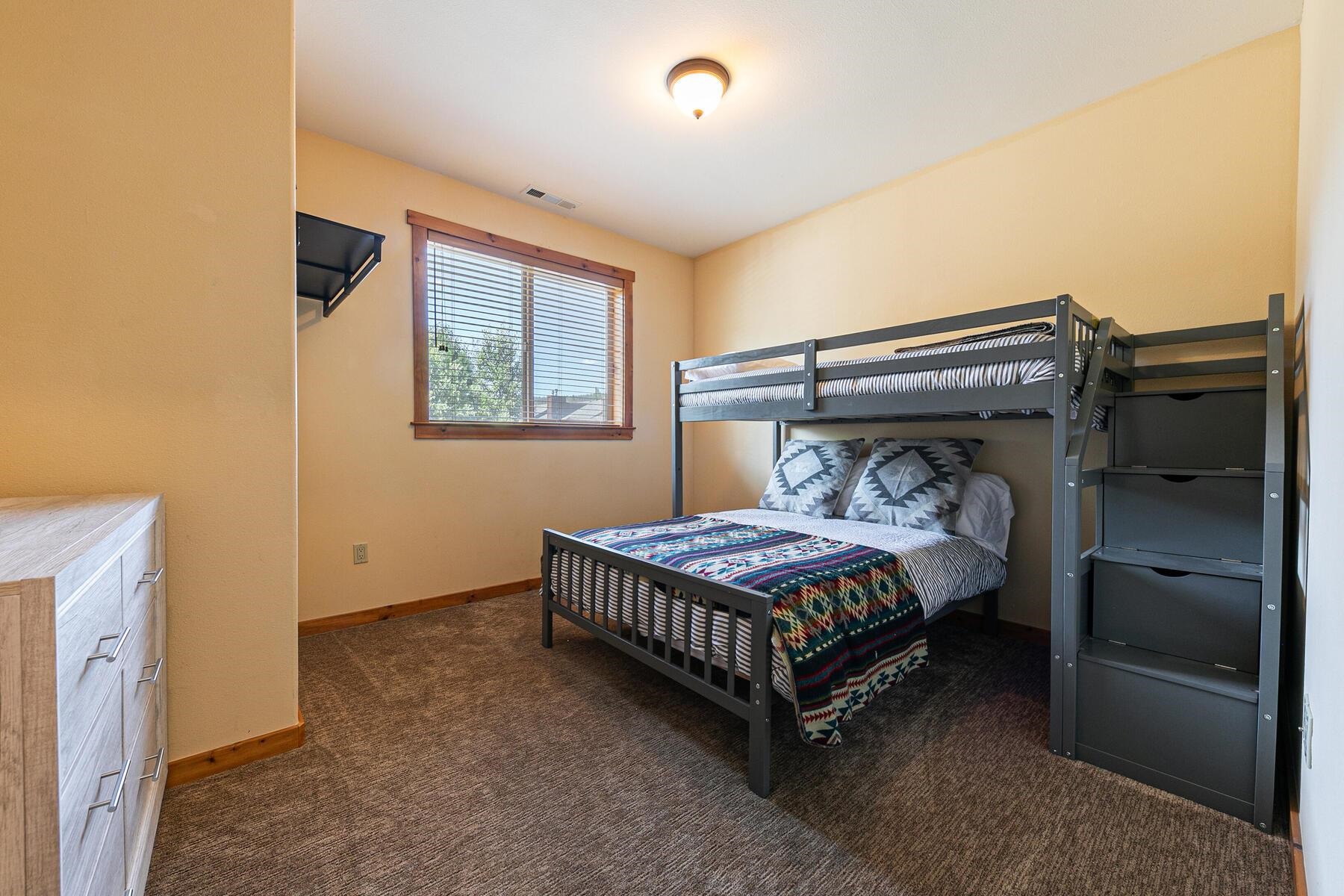 10903 Cinnabar Way, Unit 4 Truckee, CA 96161 - Photo 18 of 28 a bedroom with a bed and a chandelier