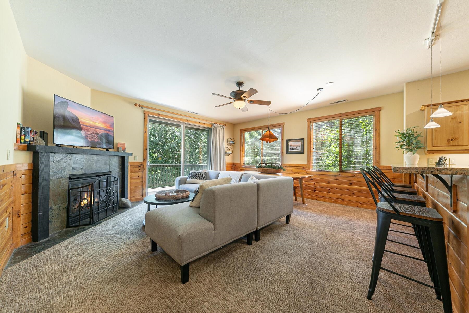 10903 Cinnabar Way, Unit 4 Truckee, CA 96161 - Photo 9 of 28 a living room with furniture a fireplace and a floor to ceiling window
