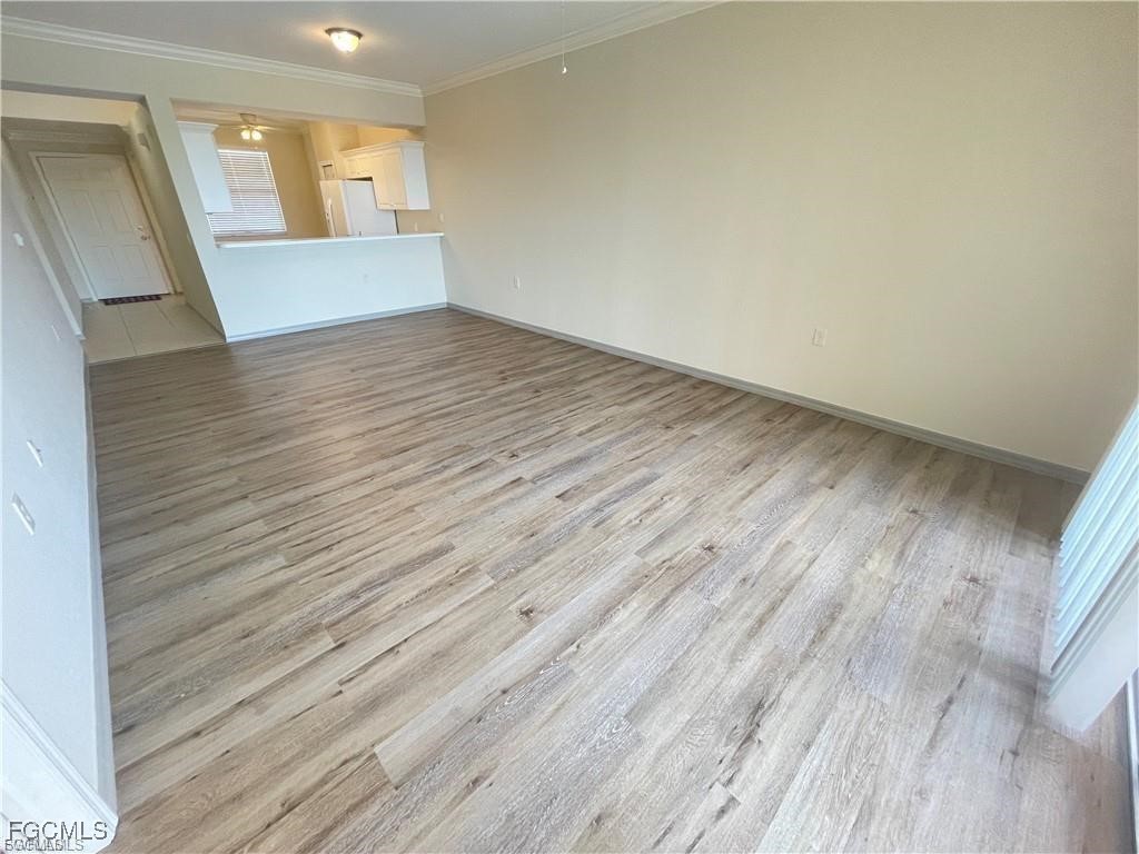 8550 Kingbird Loop, Unit 635 Estero, FL 33967 - Photo 2 of 12 an empty room with wooden floor and windows