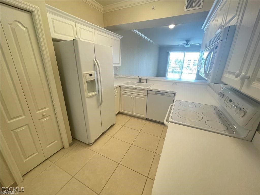 8550 Kingbird Loop, Unit 635 Estero, FL 33967 - Photo 3 of 12 a kitchen with a refrigerator a sink and dishwasher