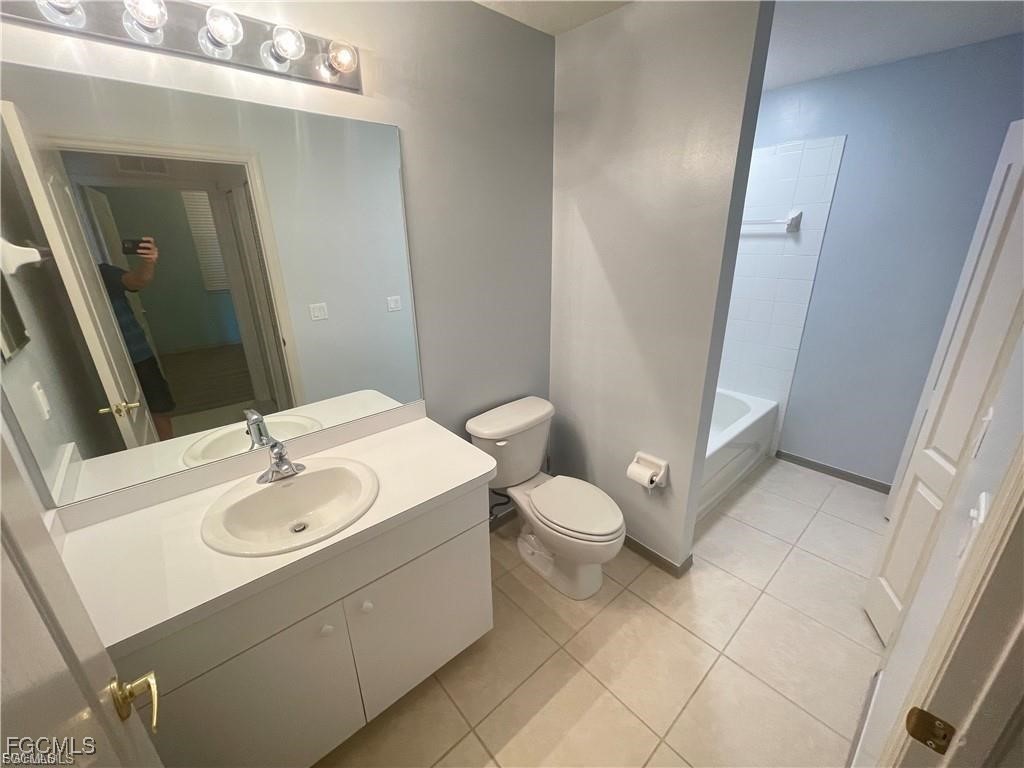 8550 Kingbird Loop, Unit 635 Estero, FL 33967 - Photo 6 of 12 a bathroom with a sink and a mirror